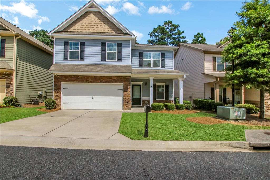 Stylish Living in The Water's Edge at River Park. Wonderfully Designed and Newly Refreshed 4 Bedroom 3 Bath Retreat. The Main Level has an Open Concept Great Room with Cozy Fireplace, Gourmet Kitchen, New Dishwasher, Large Island with Breakfast Bar, Granite Countertops and S.S. Appliances. The Living Area Opens to a Large Private Patio and Fenced Yard with Access to the Preserve Forest - Perfect for Gatherings and Entertaining. This Level also Features an Office/Bedroom, Full Bath, Mud Area off the Garage, 9' Ceilings and LVT Hardwood Floors. The Newly Carpeted Upstairs Offers 4 Bedrooms and 2 Additional Full Baths including an Expansive Master Suite and Private Ensuite Bath with Ample Closet Space. Laundry Room with New Washer and Dryer included.  Attached Two Car Garage. The River Park community Features Amazing Amenities Including Swimming Pool, Tennis Courts, Clubhouse, Fitness Center, Playgrounds, and More! Lawn Maintenance and Trash Service are Included in HOA Dues. River Park is just Minutes from Downtown Woodstock, The Outlet Shoppes at Atlanta, and top-rated Cherokee County schools, and Hiking Trails, with Easy Access to I-575