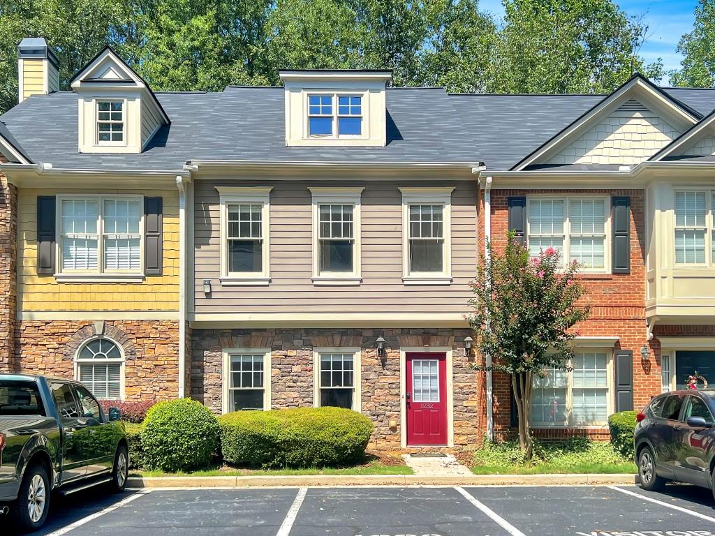 Welcome to this beautiful 2-bedroom, 2.5-bathroom townhome located in the heart of Roswell, just minutes from Downtown Alpharetta and the Avalon. The home offers an open and bright floor plan with a spacious living room featuring a cozy fireplace and luxurious LVP flooring throughout. The large kitchen boasts ample cabinet space, granite countertops, and stainless steel appliances, with an adjacent dining room. The main floor includes a convenient half bath.Upstairs, you'll find two generously sized bedrooms, each with its own bathroom and walk-in closet, along with a dedicated laundry room. Enjoy outdoor living on the large patio with a private backyard and additional storage space. Harris Commons is a peaceful, well-kept community with walking trails and a dog park. Conveniently close to Willis Park, Downtown Crabapple, and more. Welcome Home!