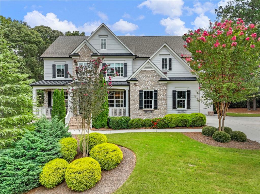Experience refined resort living in this custom-built, five-bedroom, five-bathroom home, perfectly situated within the prestigious gated community of Chateau Elan. This residence offers a rare blend of elegance, privacy and newly (2024) finished basement perfect for entertainment. A sophisticated two-story foyer with gleaming hardwood floors welcomes you into the heart of the home. The chef's kitchen recently renovated in 2025 features high-end appliances, solid surface counters, a breakfast bar, dry bar, wine cooler, ice maker, and an open layout that flows into a cozy keeping room. Enjoy the comfort of multiple fireplaces, located in the great room, master suite, and keeping room. On a cool fall night, you keep warm outside on the covered deck complete with fireplace and television. A private guest bedroom and full bathroom on the main level provide a comfortable retreat for visitors. The oversized primary bedroom on the upper floor offers a true escape, featuring hardwoods, its own fireplace and a spa-like ensuite with a double vanity, separate shower, and soaking tub. The full, finished basement dramatically expands the home's living space, providing versatile options for a recreation room, media center, and home gym, complete with a full bathroom and walk-out access. Enjoy relaxing on the spacious back deck, which overlooks a private, wooded backyard with lush landscaping. This backyard comes complete with custom turf underneath a playground. As a resident, you have access to Chateau Elan's world-class amenities, including championship golf courses, a premier sports club with tennis and an Olympic pool, and a renowned winery. This home is ideally located near the Chateau Elan resort and spa, as well as the new Braselton medical campus, major highways, and a variety of shopping and dining options.