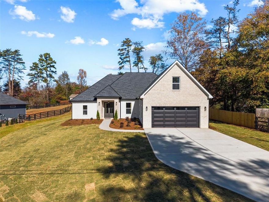 This brand new 2025 custom-built home is calling your name—ring, ring, ring! That’s the sound your phone should be making to schedule your showing or make an offer. Perfectly situated in a highly sought-after neighborhood surrounded by beautifully maintained, million-dollar homes, this property delivers modern comfort and timeless style.

Inside, you’ll find 4 spacious bedrooms and 3 full bathrooms, plus a convenient mudroom just off the garage. Soaring 10’ ceilings in the foyer, 9’ in the dining area, and 12’ in the living room create an open, airy feel. LVP flooring runs throughout (because who really wants carpet?), with sleek tile finishes in the bathrooms and laundry room—yes, a real laundry space, not a cramped corner.

The chef’s kitchen features quartz countertops, a pot filler for easy cooking, shaker-style soft-close cabinets, a wine fridge, and all appliances included. The living room boasts a floating electric fireplace for that perfect modern touch, while the exterior pairs brick and Hardie panel siding with architectural shingles—a look that stands out and lasts.

Enjoy your flat front and backyard, perfect for gatherings, outdoor games, or your creative landscaping ideas. The covered porch is already wired for a TV, setting the scene for game days and summer cookouts.

The split-bedroom floor plan provides privacy for the primary suite, and with no HOA, you’ll have the freedom to truly make this home yours—no rental restrictions, no rigid rules, just ownership your way.

Got a boat or love the water? You’re in luck—the public neighborhood dock and park are just a short walk away.