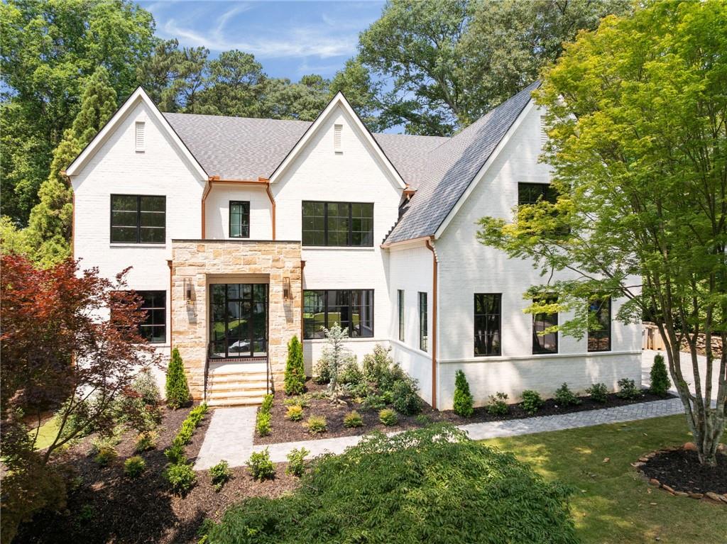 This is the one!! Stunning one of a kind new construction in the heart of Pine Hills with ROOM FOR A POOL. This exquisite brick home features a steel entry door, 5-bedroom, 5.5-bath home with a 3-car garage. Elevated design and everyday comfort just in time to enjoy the summer weather. Inside, rich hardwood floors and high-end finishes set the tone for sophisticated living. The main level offers a seamless balance of style and functionality—a moody study for quiet moments, a plaid-accented formal dining room for statement dinners, and a full guest suite for refined hospitality. A striking powder room completes the thoughtful flow. In the heart of the home, the chef’s kitchen makes a bold impression with quartz countertops, Double islands, top-tier appliances, gold hardware, and a hidden scullery finished with soapstone and a wine fridge—perfect for effortless entertaining. The kitchen opens to a warm family room with a cast stone fireplace, plus a cozy keeping room and a designer mudroom with deep green built-ins and custom cubbies. Upstairs, the owner’s suite is a serene sanctuary with beamed ceilings and a spa-like bath that includes a freestanding tub and double vanities. Each of the four additional bedrooms features its own private bath with designer finishes. A dedicated workout room and media lounge offer flexibility for wellness and recreation. Downstairs, an expansive unfinished basement invites endless possibilities, while outdoor living takes center stage with a covered patio, ceiling fan, and fireplace—an elegant extension of the living space. Perfectly positioned near premier dining, shopping, and entertainment, this residence blends artisanal design with modern luxury in a truly unforgettable way. Pool permit in place and will transfer with the sale of the home.