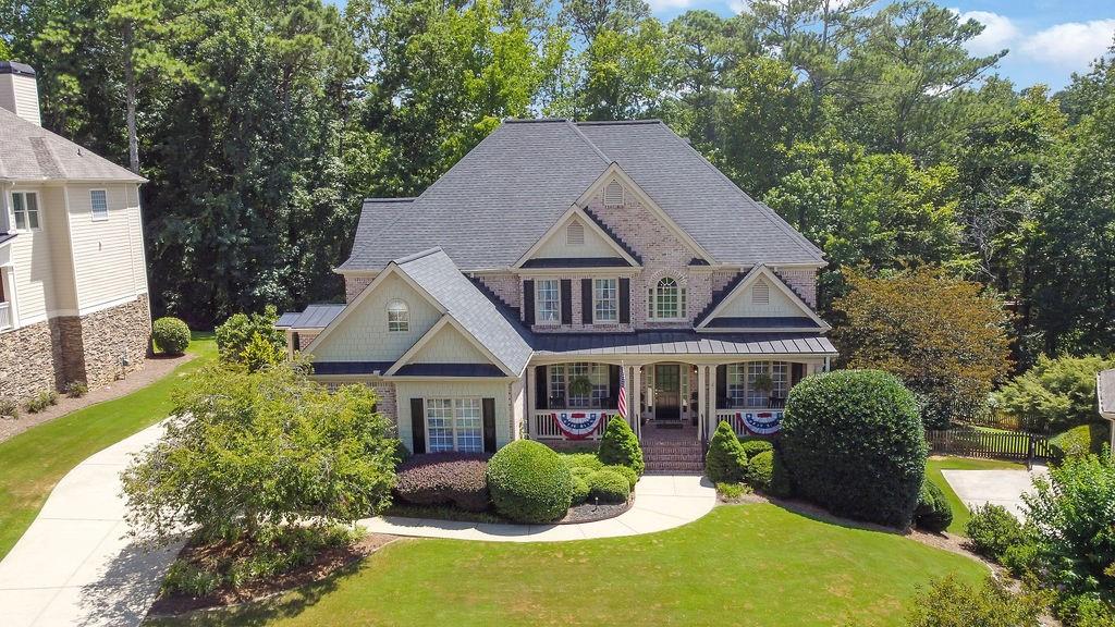 Welcome to 3215 Waterhouse Street! A meticulously maintained gem nestled in one of Kennesaw's most desirable neighborhoods! This lovely, cared-for home offers thoughtful updates and elegant finishes throughout, including a newer 30-year architectural roof (2021) and hardwood floors across both the main and upper levels. Upon entering, you’re greeted by your very own private library! A rare find, complete with custom-built-in bookshelves and designer lighting. Just across the foyer, a separate formal dining room awaits, perfect for hosting gatherings or spending quality family time. Chef’s kitchen, boasting a double oven, gas cooktop, and an abundance of cabinet space, which includes under-cabinet lighting. Two spacious living areas provide flexibility and comfort, whether you're entertaining guests or enjoying a cozy night in. The oversized garage is equally impressive, featuring epoxy floors, wainscoting, and insulated garage doors. The converted mudroom adds extra convenience and houses the laundry area with smart design in mind. Upstairs, you'll find four well-appointed bedrooms, including an expansive primary suite with tray ceilings, a private sitting area, and a luxurious en-suite bath. The walk-in master closet is thoughtfully designed with an ample amount of space and a wall-mounted ironing board for added functionality. The finished basement is an entertainer’s dream—complete with a large open living space, kitchenette, full bedroom, full bath, plus a dedicated workshop and additional storage area! Step outside and enjoy your private outdoor oasis! Relax on the low-maintenance TREX deck, gather around the stone fire pit, or admire the professionally landscaped backyard with stone retaining walls, steps, and accent lighting—a perfect retreat after a long day. Do not miss this rare opportunity to own a truly special home in Kennesaw, GA! Schedule your private showing today!