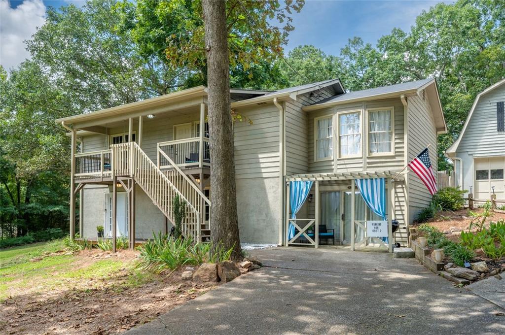 This is a fully functioning, fully furnished, short term rental. its a simple family residence that has a main level two bedroom two bath, a separate entrance, 3 1.5 on the upper level, and a detached building that includes a 1 bed 1 bath apartment and a 2 car, 2 story garage. There's also a second driveway that could be extended to the back of the property. We had envisioned building a barndominium back there at some point. Cherokee county but servicing Johns Creek, Milton and Alpharetta. This is a single family residence with multiple income streams. Bright, Roomy, country living style home. Deer roam the property. Fully Functioning and Cash flowing day 1.