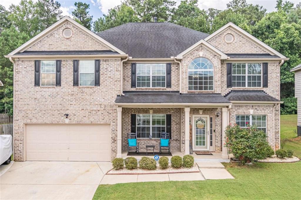 Welcome to this stunning 5 bedroom, 4.5 bath two-story home nestled in a beautiful subdivision in South Fulton. Step into the grand two story foyer that sets the tone for spacious and elegant living. The main level offers a convenient guest bedroom, a full bath and an additional half bath for entertaining. The main level also boasts a large family room, dining room, and flex room. Upstairs, you'll find four generously sized bedrooms including a luxurious primary suite complete with a large sitting room a spa-like tiled shower, a soaker tub and a large walk-in closet. The kitchen boasts a large island, granite counter tops, inset sink and gas range. It is open concept living at its best. The backyard is perfect for gatherings. There is a large raised, covered deck with great ceiling fans and an additional patio. This home combines comfort, space, and a great community in one perfect package. The community includes great amenities. There is a pool, tennis courts, playground, sidewalks and street lights. Don't let this home slip past you! Call today for a tour!