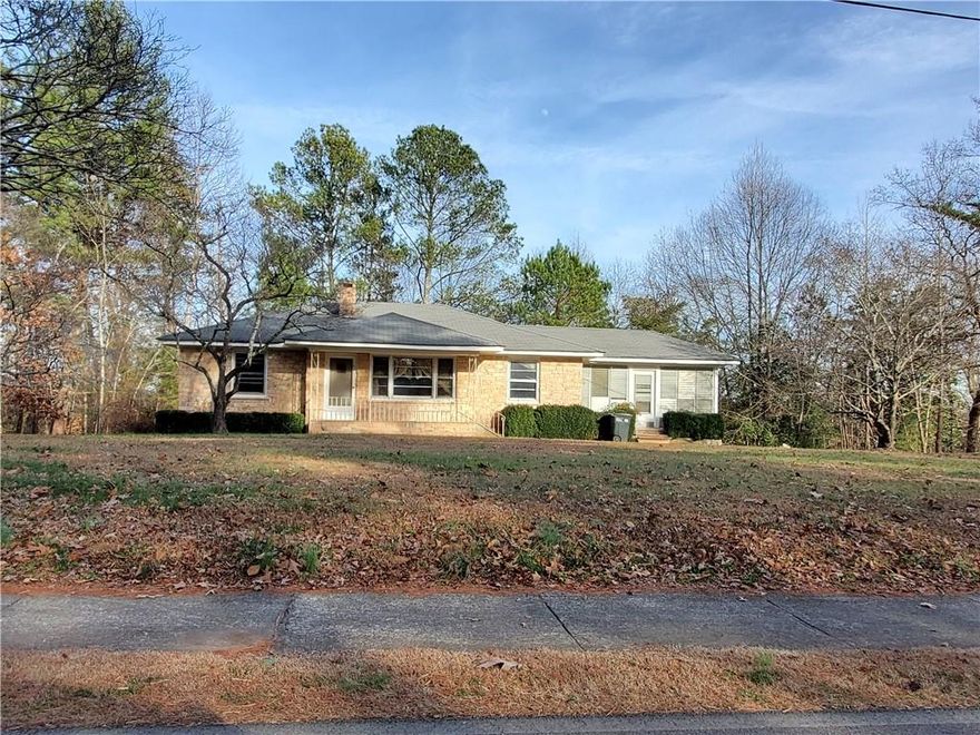 Classic Ranch Home built with Etowah Marble sitting on 7 acres of beautiful useable land. Nice Front yard with circular driveway, and private backyard. This 3 bd 1 bath home has so much charm with its Original Hardwood floors, Tong n groove walls and ceilings in some of the rooms. Original Italian Marble kitchen countertops. Fireplace is also built from the Etowah Marble and has the Italian Marble mantle and inset. Sunroom is large and has Etowah Marble Floor. This lovely home has so many features and is truly a gem waiting for a new Owner to make it their own. Property is Conveniently located to everything and only 3 to 4 min to Historic downtown Ball Ground.
