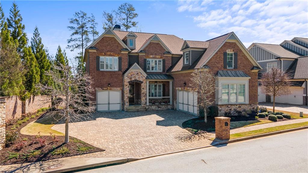 Welcome to this stately 4-sided brick executive home located in the heart of East Cobb. Fantastic new saltwater pool with a soothing waterfall, sauna and hot tub adorned with impeccable landscaping. Located in top Cobb County Schools, nearby shopping and restaurants and minutes away from downtown Roswell. Sunny open floor plan with extra-large Dining and Family rooms. Beautiful gleaming hardwood floors and plantation shutters throughout the main level. A true gourmet chef's kitchen that overlooks the family room with a wall of shelving and fireplace has it all. Kitchen has a large island, top end stainless steel appliances, double oven, gas cooktop, counter depth fridge, enormous panty, sleek cabinetry with white stone counter tops and tiled backsplash. Nearby Wet Bar features glass cabinetry, wine cooler and filtered water sink. Bright and Cozy Keeping room with a second fireplace overlooks the pool and leads to the covered deck. Main floor also features a Guest bedroom with a full bath. Three car garage leads to a large mudroom and workstation with a built-in desk. Fabulous second level Master bedroom with a sitting room, beautiful bathroom that features double vanities, soaking tub, walk-in shower and closet so large you have to see to believe! Three additional bedrooms upstairs with en suite bathrooms and laundry room with cabinets and sink. Recently finished Terrace level has a bedroom, full bath, built-in bar, and two large rooms for media, playroom, exercise or whatever your heart desires. Access the yard from the terrace level to a covered patio and enjoy your private outdoor retreat all  all year long.