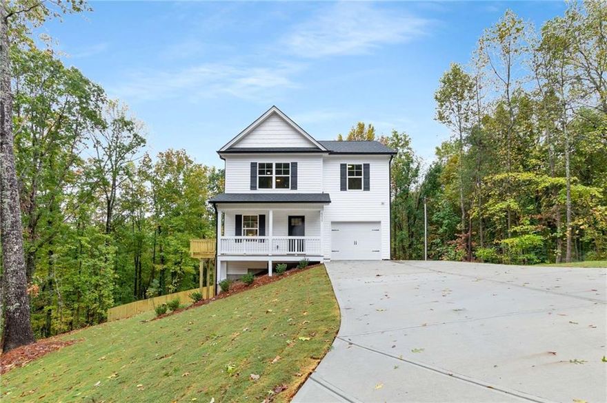 Nestled on a beautiful wooded lot across the street from the serene shores of Lake Lanier, this stunning3BR/2.5BA new construction home on a full unfinished basement offers an open floor plan perfect for modern living. The main level features an open-concept layout, ideal for entertaining guests or relaxing with family. The well-appointed kitchen is complete with SS appliances, quartz counter tops, tile backsplash, white shaker cabinets, LVP floors t/o the entire home, and ample countertop space. The spacious master bedroom features a vaulted ceiling, his and her closets, and is located on the other side of the secondary bedrooms. The master bathroom contains a shower/tub combo and separate his and her vanities as well as a large walk in closet. A full, unfinished basement allows for future expansion.  Conveniently located near Cumming, Gainesville, and Dawsonville, you'll have easy access to shopping, dining, and entertainment options.  Agent/owner.