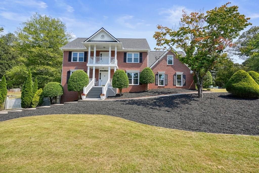 IMMACULATELY MAINTAINED brick Colonial in one of Woodstock's most sought-after neighborhoods, WILLOW CREEK! Lovingly cared for by its ORIGINAL owner, this stately 5-bedroom, 2 1/2 bath Colonial home combines timeless charm with meticulous upkeep. The builder of this home built this house after a home in Southern Living Magazine! Step inside to find spacious living areas filled with natural light, a tiled sunroom for morning sun coffee, a bonus space on the main level that could be used as an office, playroom, library, or anything your heart desires. There's also the convenience of two staircases. The home’s oversized secondary bedrooms provide comfort and flexibility for family, guests, or home offices. An unfinished basement with a workbench (perfect for anyone who likes to work with tools or wood-working) offers excellent storage with endless potential for future expansion. It already has plumbing to add a bathroom, too, making it a great in-law suite with exterior and interior entry! Recent UPGRADES include NEW windows (2025), NEWER roof (2021), NEW carpet (2025), interior and exterior repainted (2025), NEWER HVAC, WHOLE house water filtration system, the list goes on and on. NEWLY refreshed 5-CAR GARAGE features fresh paint, 2 with epoxy flooring, and room to store multiple vehicles, plus space for a boat, four-wheelers, or a golf cart. A storage shed with electricity adds even more functionality. Outdoor living is equally impressive, with a covered back deck for year-round enjoyment and a private balcony—the perfect spot to relax and watch the sunset. Set in a fantastic neighborhood spanning two counties, your family would enjoy access to two community pools, a swim team, and welcoming amenities. The location is unbeatable—just five minutes from downtown Woodstock and close to highly rated schools, restaurants, and excellent shopping. If you're looking for a spacious home without the million-dollar price tag, this is the perfect place for your family to create memories for years to come with room for everyone to live, play and grow together. EVERYTHING has been done for you! Come see for yourself!
