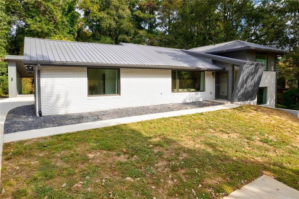 Executive Rental. FULLY FURNISHED SHORT OR LONG TERM. What a wonderful Experience to live in this Furnished Executive Rental with TWO Primary Suites- One Upstairs and One on the Main. Relax in this Mid Century Modern Home within walking distance to Chastain Park, Gateway of Sandy Springs(dining and shopping)and walking trails. Recently renovated and decorated with designer touches throughout. Five bedrooms, four baths and comfortably sleeps up to 10 people. One of the rooms does double duty as an office/ study, and the two chair beds unfold to sleep two additional adults or children. Open kitchen floor plan for cooking, dining and entertaining while the downstairs rec room offers a big TV and comfy couch for watching shows, a pool table, bar, and even a Ms Pac Man / Galaga arcade video game! Wi-fi, high-speed internet, Netflix, Amazon Prime Video and Peacock are included.