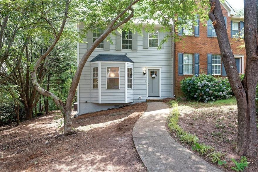 Welcome home to this updated 2 bedroom 2.5 bath end-unit townhome in a quiet Marietta community. Centrally located only 4 minutes to I-75 at GA-120 (Exit 265), KSU (7 minutes) the Marietta Square (10 minutes), Truist Park (12 minutes), and only 15 minutes to downtown Roswell. LVP flooring throughout both levels—no carpet! The kitchen features granite counters and an eat-in Breakfast Nook with a bay window for lots of natural lighting. The Family Room features a Fireplace with a brick hearth and open Dining Area. Overlooking a serene wooded view, the oversized two-level deck provides additional entertaining area off the main level, while the second level deck offers a quiet place to relax off the Master Bedroom. The second upstairs bedroom also features its own full bath and walk-in closet—perfect for a roommate arrangement! Convenient to shopping, dining, and top schools. 2-car parking pad in front of home. **APPLICATION REQUIREMENTS: Minimum 650 credit score, clean background report, and no past evictions. No smoking. Pets negotiable.** Available for move-in on 12/1/25.