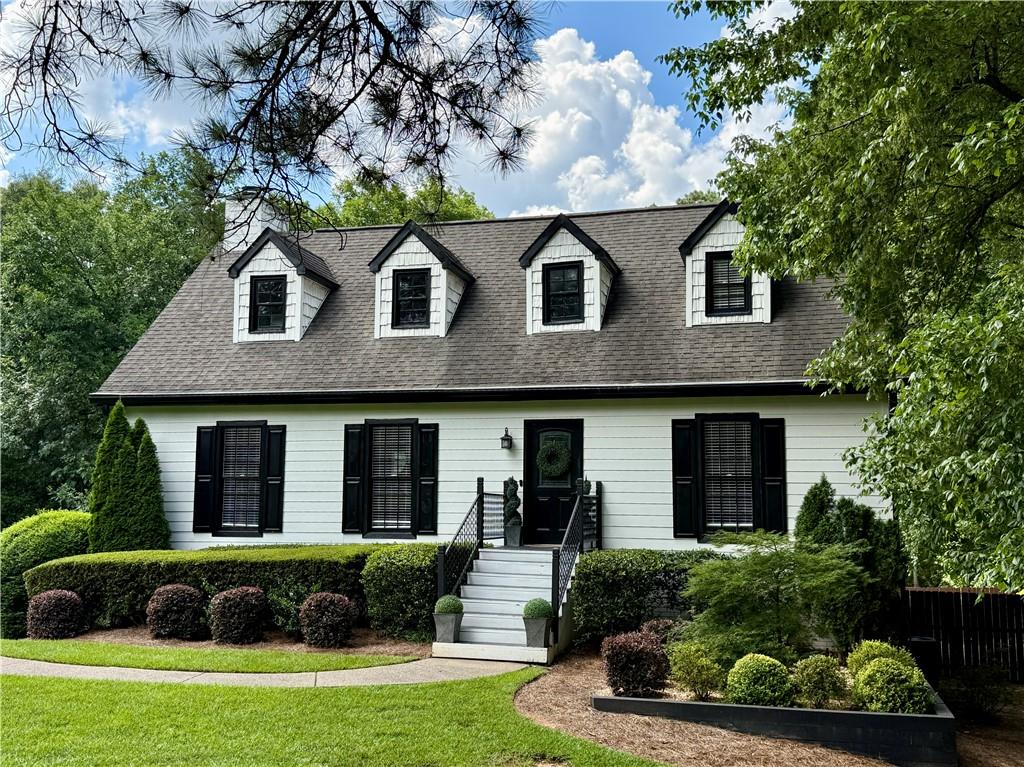 This stunning two-story Cape Cod residence is situated in one of the most sought-after golfing communities in East Cobb – Indian Hills. The main level features gorgeous hardwood floors throughout. The newly renovated bright and white kitchen is equipped with stainless steel appliances and stone counter tops. A spacious deck overlooking the over-sized corner lot is accessible from the kitchen. The private backyard extends well beyond the fenced area and is perfect for adding a pool. The primary suite is located on the main level, while the second primary suite upstairs boasts a huge walk-in closet and a second bedroom. Each bedroom has its own bathroom. The home is filled with an abundance of natural light. Notably, this residence also features a finished basement with a fourth bedroom, a bonus recreation room/office, and a two-car garage.