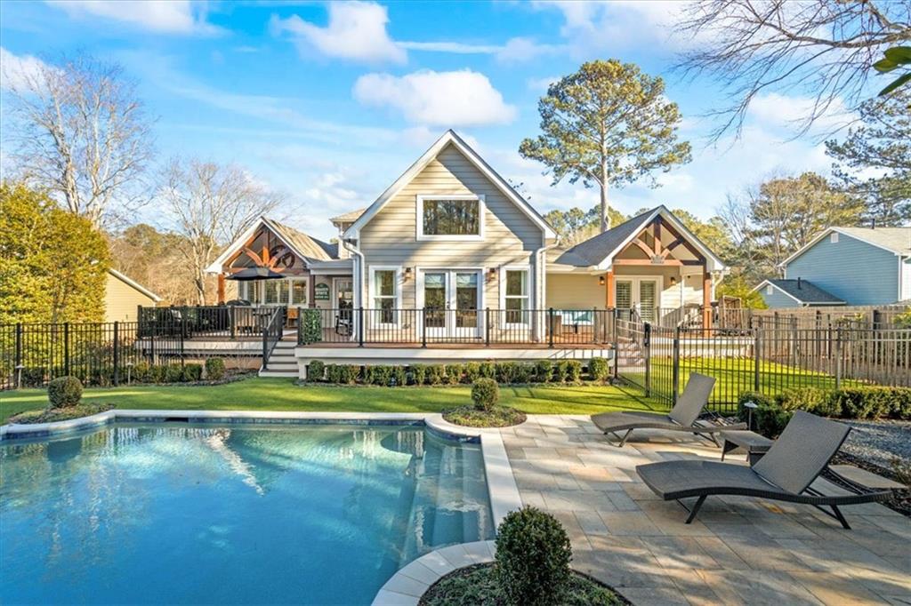 Instant equity with below appraised value pricing - welcome to 3051 Maple Ln., where timeless elegance meets modern luxury in the heart of Alpharetta! This extraordinary home has been meticulously redesigned and rebuilt from the ground up, with a complete renovation finished in 2022. Situated on nearly half an acre and walking distance to downtown Alpharetta, this residence offers the perfect combination of sophistication, comfort, and convenience. As you step inside, you're greeted by a stunning open floor plan with engineered hardwood floors throughout, custom cabinetry, and exquisite finishes at every turn. The heart of the home is the chef's kitchen, featuring Jenn Air appliances, a built-in refrigerator, a custom butler pantry, and sleek countertops, making it ideal for entertaining and everyday living. The home boasts 4 spacious bedrooms and 5.5 luxurious bathrooms, including a main-level primary suite that feels like a private retreat. With direct access to the wraparound patio and backyard, this suite offers a custom spa-like bathroom and a designer walk-in closet. Upstairs, you'll find the original master suite with a fully remodeled en-suite, a secondary bedroom, and a loft space perfect for relaxing or working from home. The finished basement is equally impressive, currently designed as a wellness space with 3 separate rooms, a kitchenette, a second laundry room, and a large sitting area. A curved wall leads to a private outdoor entrance, offering endless possibilities for use. Step outside into your personal oasis, complete with a saltwater pool, custom fire pit seating, turf lawn, and iron fencing. The fully fenced backyard also features a dedicated turf area for pets, along with professional landscaping and outdoor lighting that create a serene and inviting atmosphere. Additional features include a 3-car garage, gas lanterns on the front porch, plantation shutters throughout, a tankless water heater, foam insulation, a $5K water filtration system, a state-of-the-art security system, and much more. This home is truly one of a kind, offering luxury living with no HOA and an unbeatable location just steps from all that downtown Alpharetta has to offer. Don't miss the opportunity to call 3051 Maple Ln. your forever home. Schedule your private tour today and experience the epitome of modern luxury!