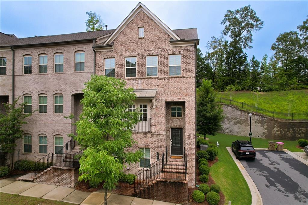 Premium Townhome in Suwanee Town Center -- Welcome to this expansive three-story townhome featuring 4 bedrooms, 3.5 bathrooms, and approximately 2,424 square feet of refined living space. Built in 2019, this property showcases a timeless brick exterior and is nestled on a 1,306 sq ft lot. Inside, the open-concept layout invites you with a warm ambiance, complete with a fireplace and elegant finishes. The chef-ready kitchen pairs functionality with style, stainless steel appliances, white cabinets and stone countertops. Just steps from the Suwanee Town Center, shopping, greenway, dining, and top-rated schools -- low-maintenance living at its finest!