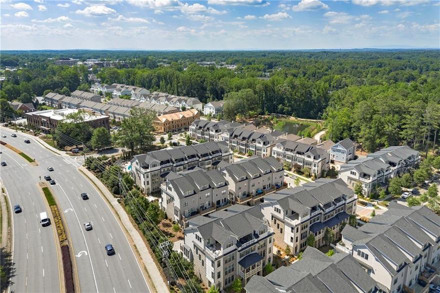 This sunny end unit offers plenty of natural light throughout. Enjoy the convenience of your own Private Elevator and spacious layout — perfect for easy living and entertaining. This home is great for people watching located in between the Avalon and Downtown Alpharetta, walk to both! Rooftop and off the kitchen deck for entertaining or just being nosey.