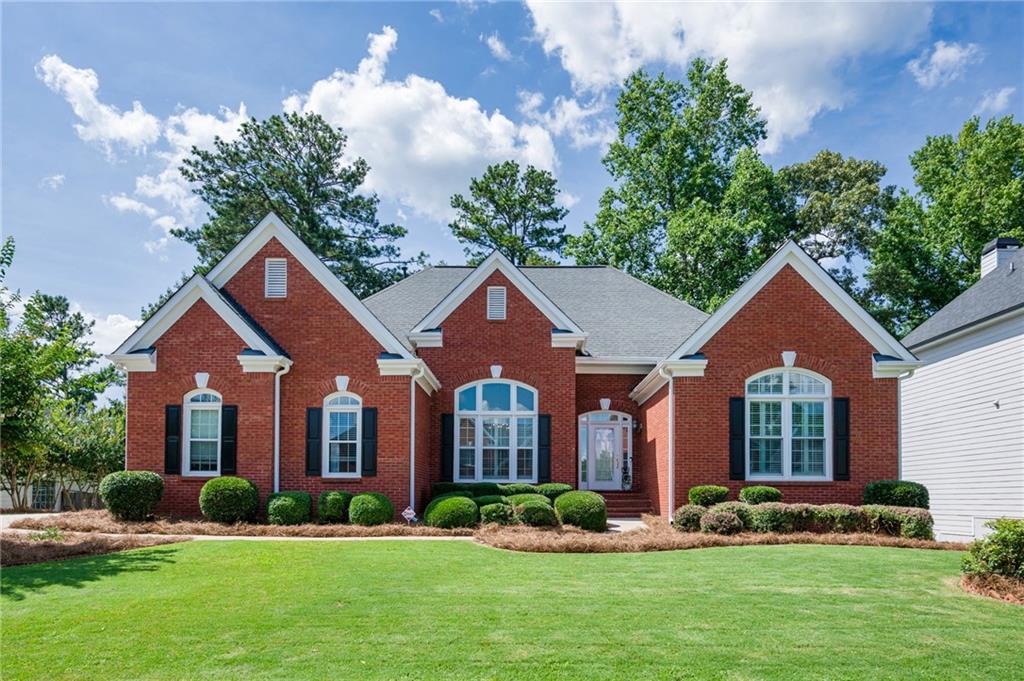 Welcome to this rare ranch-on-basement home in the heart of Suwanee, just a short walk to top-rated North Gwinnett Schools! This spacious and beautifully maintained 4-bedroom, 3.5-bath home features an open-concept layout with hardwood floors throughout—no carpet anywhere. The light-filled living and dining rooms flow into a large kitchen with an island, walk-in pantry, and executive desk, all opening to a vaulted fireside family room. Enjoy your morning coffee or evening relaxation on the covered screened-in porch and expansive deck overlooking a huge, flat backyard with a new privacy fence. The sought-after master-on-main offers his and her closets, while a spacious bonus bedroom with a full bath awaits upstairs. The clean, daylight unfinished basement is ready for your custom touch. Recent updates include newer HVAC, fresh paint, and great curb appeal. Located on a quiet cul-de-sac with a flat driveway and 2-car side entry garage—this move-in-ready gem won’t last long!