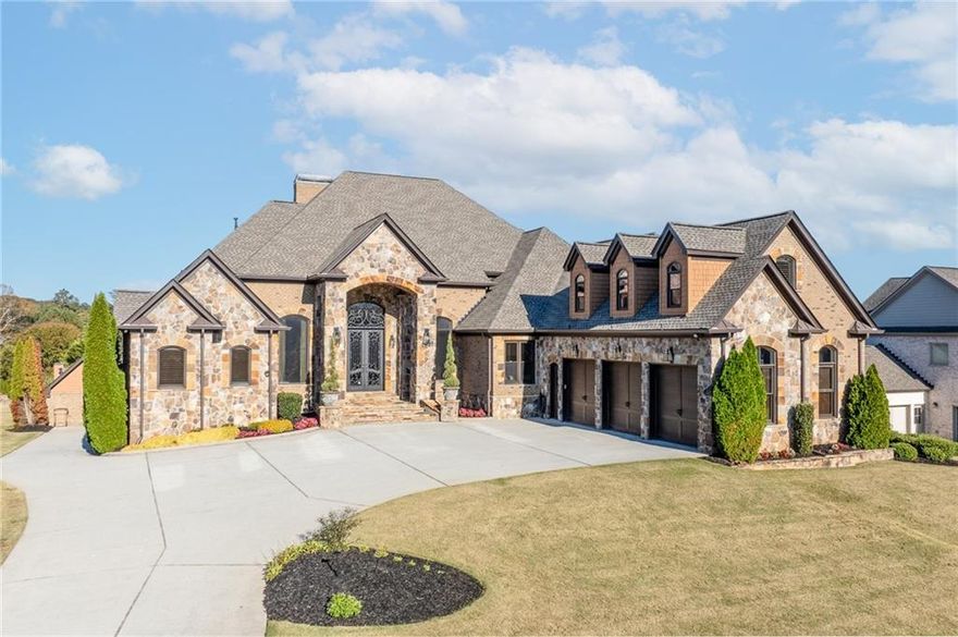 This one is a showstopper!! You'll fall in love the moment you enter the front door. Bright open spaces, THREE kitchens ready for family gatherings and a cozy living area made for quiet evenings. The bedrooms are spacious and inviting with each having a private bathroom, The backyard is perfect for weekend cookouts, soaking in the hot tub, swimming, or just relaxing while sipping sweet tea as the sun sets. Want to watch a movie in your PJs without leaving the house? We have that too! Located in one of Hoschton's most sought-after neighborhoods, this home is convenient to EVERYWHERE!