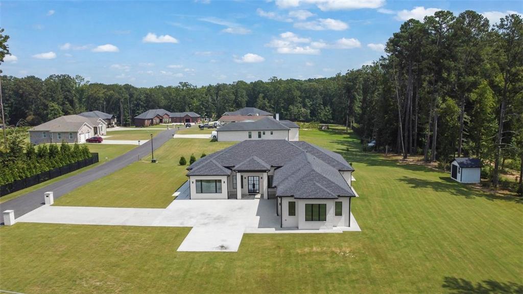 This beautiful ranch home offers comfort, flexibility, and efficiency on a full acre with no HOA. The interior is filled with natural light from oversized windows, paired with deluxe blinds that adjust from open daylight to complete privacy. Real hardwood floors with a durable mono coat finish are installed over insulated subflooring, providing long-term durability and temperature control.
The open layout includes a dedicated office/flex space, ideal for remote work or running a small business from home. Inside you’ll also find extra closets for added storage, and outside a shed for lawn equipment and essentials. A long driveway leads to a 3-car daylight garage with plenty of space for parking and projects.
Built for efficiency with two HVAC systems, four-side brick, and full insulation, this home keeps utilities low with only water and electric (on septic).
Unbeatable location: walking distance to Hebron Christian Academy, zoned for excellent schools, and minutes to Hamilton Mill, Mall of Georgia, Topgolf, Andretti, golf, and parks.
A rare opportunity for modern ranch living with abundant storage, home-business potential, and a private 1-acre setting with no HOA.