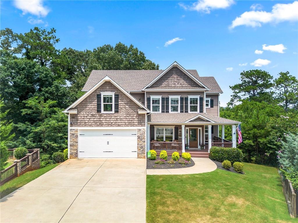 Welcome home! Flawlessly crafted and thoughtfully designed, this 4-bedroom 3 bath with office/flex space and unfinished basement home sits tucked at the end of a quiet cul de sac on nearly half an acre in the heart of Cartersville. Built in 2018, a grand two-story foyer layered in elegant details welcomes you into the home, leading effortlessly into expansive living spaces centered around the graceful living room fireplace. Gleaming hardwood floors and coffered ceilings add richness and character throughout the main level. The kitchen, both functional and stylish, features stainless steel appliances, high end granite counter tops, and a central island with a cozy breakfast nook, all flow into the open concept family room. Perfect for gathering or quiet moments, the screened in back patio overlooks a lush tree lined backyard, creating a peaceful backdrop for indoor outdoor living. A flexible and intuitive layout includes a main level guest bedroom with full bath, ideal for visitors, aging in place, or a private home office. Upstairs, the primary suite offers a quiet retreat with tray ceilings, spa inspired bath with double vanity and walk in shower, a sitting area, and a generous walk-in closet. Two additional upstairs bedrooms and a spacious media room or flex office adds extra versatility to the second floor. An unfinished daylight basement offers endless potential for customization whether for recreation, additional living space, or storage. Located within the Cartersville School district, this home combines elegant design, smart functionality, and room to grow all nestled in a peaceful, well-established neighborhood minutes from Cartersville Primary. Don't miss out on this home! Schedule a private showing today!