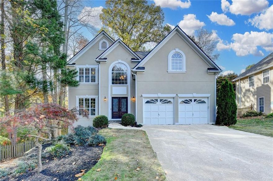 Beautifully updated and move-in ready, this Roswell home offers modern style, exceptional outdoor living, and a flexible finished basement—all within minutes of Downtown Roswell, top-rated schools, parks, shops, and restaurants. A bright two-story foyer welcomes you in, showcasing rich hardwood floors, elegant trim work, and great natural light throughout. The main level includes a spacious dining room and a versatile front living room or home office. The renovated kitchen is the heart of the home, featuring white cabinetry, quartz countertops, stainless steel appliances, gas range, designer lighting, and an island—all with clear sight lines into the cozy fireside family room. Exposed beams, custom built-ins, and a marble-surround fireplace create a warm and inviting space for everyday living. Step outside to one of the home’s best features: an expansive screened-in porch with a peaceful wooded view. The adjoining deck is perfect for grilling, gatherings, and outdoor dining, while the lower patio leads to a charming firepit area. The fenced backyard offers privacy, mature trees, and room to play or relax. Upstairs, the oversized primary suite feels like a private retreat with a beautifully renovated spa bath featuring a freestanding soaking tub, frameless glass shower, dual vanities, designer tilework, and vaulted ceiling. Additional bedrooms are generously sized with great natural light and storage. The finished basement provides incredible flexibility, including a large media/rec room, dedicated gym space, a spacious office area(or 5th bedroom), and additional storage—ideal for work, workouts, hobbies, or kid/teen hangouts. This home truly has it all—modern updates, flexible living spaces, outdoor entertaining, and an unbeatable Roswell location in a highly sought-after school district.