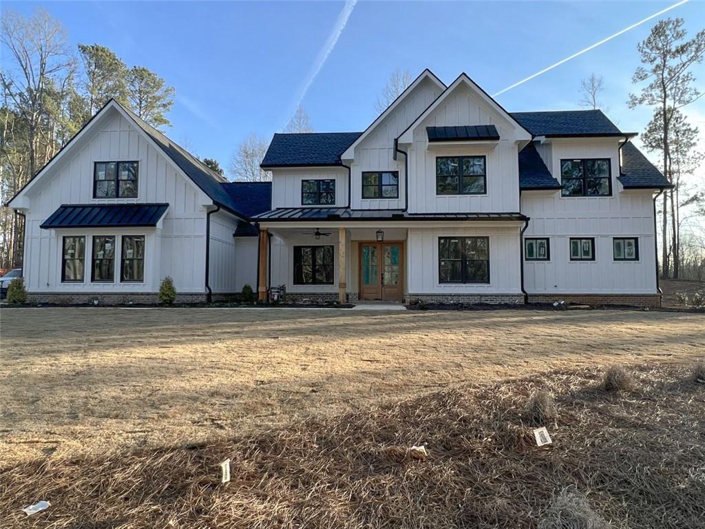 Real gem in the woods. New build modern farmhouse on over one acre at the final stage of construction. Last available in a small community in Woodstock. Conveniently located just off Arnold Mill. On approximately 4,400 Sq Ft finished area with three car garage and 600 Sq Ft bonus space over the garages. The home has an open modern floor plan with vaulted ceilings in the kitchen, dining and sunroom overlooking the living room with brick cozy fireplace. Access to a private patio from the living and dining. Master suite with spa-like bathroom, huge walk-in shower with Kohler shower system and free standing tub, his and her closets and generous laundry. Also on the first floor you will find office/guest room with full bathroom. Three bedroom suites with three bathrooms on the second floor plus office and open loft/media room. All high quality materials and fixtures. The kitchen is completed with big walk-in pantry, upgraded cabinets with inserts, exotic quartz countertops, island farmhouse apron sink, upgraded Zline appliance package including: dishwasher, 36" gas stove with 36" vent hood, microwave drawer, refrigerator. This house is loaded with upgrades. Beautifully landscaped front and back with irrigation system. Hurry to claim your new home. Ask about our backyard landscape proposal.