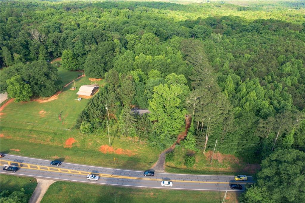 PRIME LOCATION! Potential Commercial Location with many Commercial Buildings close by and has been verified by County Commissioners. 210 Feet of Road Frontage on Hickory Flat Highway. +/- 18,000 Daily Traffic Count. Convenient to both Highway 575, Hwy 20, and Northside Hospital Cherokee. Home on the property will need to be torn down.