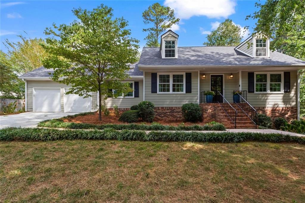Located in the heart of East Cobb and zoned for top-rated Walton High School, this charming 3-bedroom, 2-bath home sits on a private lot tucked away in a heavily sought out swim/tennis community. With hardwood floors and fresh paint throughout, and a smart floor plan that offers both a great flow yet some privacy, this home will check every box. The primary suite on the main level with a private bathroom offers the convenience of single floor living. Upstairs are two additional bedrooms along with a full bath and an unfinished walkout attic that could be a future bonus room. The kitchen offers granite countertops, stainless appliances and a cozy breakfast nook, with great views of the backyard. Additional main level spaces include a dining room, a formal living room (perfect for a home office), and a family room with a wood-burning fireplace. From the family room you can venture outdoors to the covered porch to dine or to just relax. One of the standout features is the full basement which is partially finished offering a blank canvas with tremendous possibilities for a future living space, a home gym, media room, or workshop. A new roof adds peace of mind, and the large, fenced backyard provides privacy and plenty of space for pets, play, or outdoor gatherings. Essentially maintenance free, you will love the fact that all the windows have already been replaced and the home has a brand-new hot water heater. Enjoy being just minutes from East Cobb’s best shopping, dining, and parks, with easy access to major commuter routes. Whether you're looking for top-tier schools or simply want to be in the center of it all this home delivers the perfect East Cobb lifestyle.