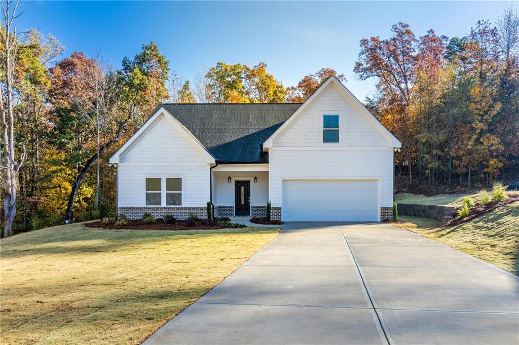 NEW CONSTRUCTION IN COMMERCE COULD BE YOURS! Custom built Ranch with upstairs bonus and full bath. Nestled in an established neighborhood on private cul-de-sac. Level lot with cozy, covered front porch and professional landscaping, including sod front and back and sprinkler system. Extra large formal foyer, greets you, with luxury LVP throughout main living area and a view to family room with open concept kitchen. Great room has stunning corner brick fireplace with gas starter. View to cheery and bright new kitchen with large granite island, plenty of room for 4 bar stools. Impressive stainless steel sink centers the island and dishwasher convenient for easy access. Large eat in kitchen with a wall of windows and beautiful pendant lighting. Extra large walk in panty, beautiful grey large subway tile for back splash and impressive granite, two pendants lights complete this gourmet kitchen. Large laundry with beautiful marble tile, built-in cabinets upper and lower with granite countertop. Two secondary bedroom with lots of light, new plush carpet on main level. Full size bathroom in hall to be shared with tile floor, tub/shower combo, granite vanity with lots of storage. Primary bedroom on main with large walk in closet and stunning ensuite'. Full spa-like bath with separate tiled shower and garden tub, Elegant leaded window above soaker tub and gorgeous pendant lighting, double vanities, with granite top and loads of storage. Upstairs is a grand bonus room and full bathroom, ideal for teen or guest. Front facing two-car garage with opener. Covered back patio that has a private view of large sodded lot, surrounded by woods, don't be surprised if you see a deer or two. Stainless steel appliances have been installed since photos and home is ready to go. This will be a great house to relax and enjoy the good life. Be the first one to live there! Home is turn key ready! BUILDER INCENTIVES!