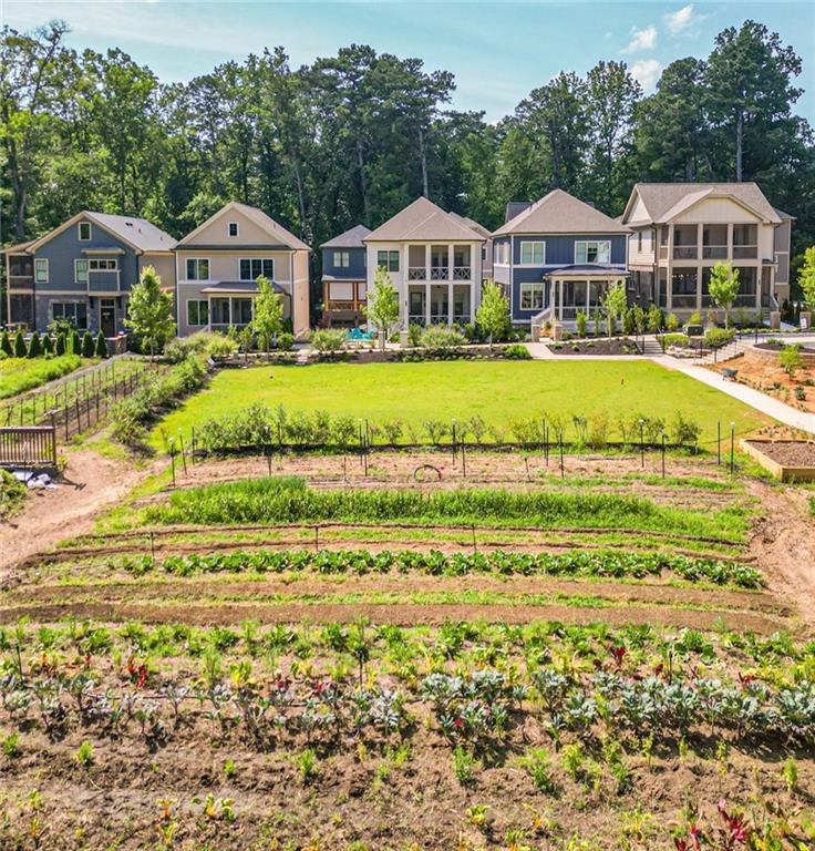 Live Where Nature and Innovation Meet — Welcome to Pendergrast Farm. SPECIAL INCENTIVE - Seller is including a full year of weekly CSA delivery from the Farm! Described by Urbanize Atlanta as “a mini-Serenbe taking shape around ITP Atlanta.” Pendergrast Farm is more than a place to live — it’s a lifestyle rooted in conservation, connection, and comfort. This visionary community brings together modern luxury and environmental stewardship. Designed to honor the land’s legacy, Pendergrast Farm features 20 high-performance homes artfully arranged around a thriving 1-acre urban farm — the heartbeat of a truly farm-to-table lifestyle. Residents enjoy fresh, organic produce delivered right to their doors every month of the year, along with breathtaking views of preserved woodlands and the peaceful sounds of a meandering stream. Here, you’re not just buying a home — you’re joining a conservation community unlike any other. Stroll or jog along 5.5 acres of wooded trails. Refresh in the saltwater lap pool. Connect with neighbors at the architecturally striking Community House, where wine tastings, chef-led cooking classes, yoga, book clubs, and private events unfold in the state-of-the-art commercial kitchen and open gathering space. Creative spirits will love the Maker’s Space below, perfect for woodworking, crafting, and hobbies of all kinds. Out-of-town guests? Host them in one of two fully appointed guest suites reserved exclusively for residents. All of this, just minutes from the city — ideally located near Briarcliff and Clairmont Roads, providing quick access to Emory, CHOA, the CDC, Decatur Square, and everything intown Atlanta has to offer.
Set against the backdrop of protected woodlands, this exceptional residence combines warm modern design with eco-conscious construction. The open-concept floor plan is bathed in natural light, thanks to expansive windows that frame stunning wooded views.
Two inviting outdoor living areas bring the forest even closer: a spacious screened deck off the main-level family room, ideal for evening wine or morning coffee, and a second outdoor lounge below, offering another serene spot to connect with nature.
The show-stopping chef’s kitchen is both functional and fabulous, featuring a 36” six-burner JennAir Pro gas range, vented hood, ultra-quiet 38 dBA JennAir dishwasher, French door counter-depth refrigerator, and built-in microwave. White oak site-finished hardwood floors and soaring 10-foot ceilings on the main level (with 9-foot ceilings upstairs and down) elevate the sense of space and light.
The primary suite is a true retreat, boasting a vaulted and beamed ceiling and a spa-worthy bath with a double-headed shower, oversized soaking tub, and elegant Moen fixtures. Upstairs, two secondary bedrooms share a full bath, while the main-level guest room features its own ensuite — ideal for visiting family or work-from-home flexibility.
Downstairs, the fully finished terrace level offers a private guest suite with its own lounge space and full bath — perfect for extended visits or a separate media room or home office.
Additional features include:
Pre-wired 60 AMP EV charging outlet
Energy-efficient spray foam insulation
Moen plumbing fixtures throughout
Thoughtful, flexible layout designed for multi-generational living or hosting
Don’t miss this rare opportunity to be part of a groundbreaking conservation community that seamlessly blends sustainability, luxury, and urban convenience. At Pendergrast Farm, you’ll live beautifully — and leave a legacy.