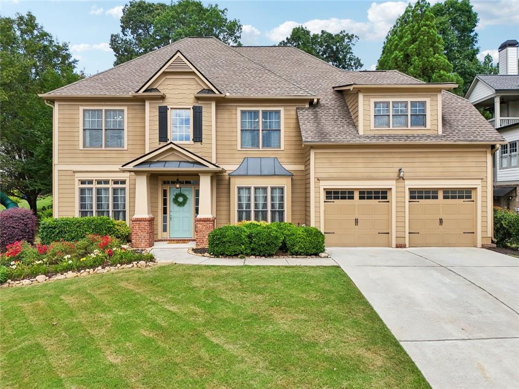 Welcome Home! This a truly beautiful 5-bedroom home in the Treybryne section Hamilton Mill community. From the moment you enter, you’ll be captivated by the soaring two-story great room filled with natural light, featuring a cozy fireplace flanked by custom built-in bookcases. A separate formal living room/study or office and dining room offer ideal spaces for entertaining and everyday living. The open-concept kitchen is designed for both style and function, tons of storage in the shaker-style cabinetry, newer stainless steel appliances, gas cooktop and built-in oven, island & breakfast bar area. Large custom pantry with solid wood shelving provide plenty of space for cooking and gathering. Just off the kitchen, enjoy the serene, screened porch that overlooks a private, fully fenced, park-like backyard — a true outdoor oasis. Relax to the sounds of the koi pond water feature, take in the beautifully landscaped surroundings, or unwind on the charming swing under the trees. Inside, the main level includes a spacious guest bedroom and full bath — perfect for visitors or long-term guests. Upstairs, you’ll find an incredible master suite with two walk-in closets and a spa-like bathroom featuring a vaulted ceiling, soaking tub, separate shower, and dual vanities. 3 additional spacious secondary bedrooms offer plenty of room for family, guests, or hobbies. Located in a vibrant swim/tennis community with access to top-rated schools, parks, shopping, and more — this home truly has it all. Don’t miss your opportunity to make this gorgeous Hamilton Mill home your own!
