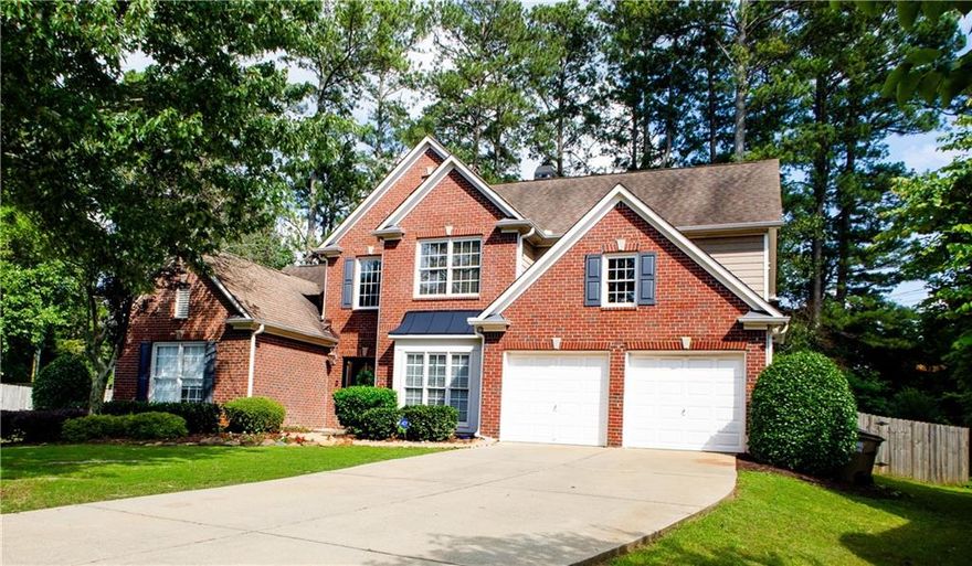 Discover the perfect blend of space, style, and location at 2720 Stillwater Lake Lane in Marietta. Tucked away on a quiet cul-de-sac in the sought-after Stillwater Lake community, this 5-bedroom, 4-bathroom home offers over 3,300 square feet of thoughtfully designed living space. The main-level owner’s suite provides comfort and privacy, while the open-concept layout features a soaring two-story great room with a stunning wall of windows that floods the space with natural light and offers views of the private, fenced backyard. A double-sided fireplace connects the living area to a gourmet kitchen with a large island and double ovens—ideal for entertaining and everyday living. A second bedroom and full bath on the main floor add flexibility, while upstairs, three spacious bedrooms include a Jack-and-Jill bath and a private en-suite. Throughout, you'll find plenty of storage and little touches of character that set this home apart from cookie-cutter builds. The backyard patio offers a peaceful retreat perfect for relaxing or play. Walkable to the community pool, playground, and clubhouse, as well as nearby restaurants and schools, this home delivers the charm, convenience, and comfort you’ve been looking for!