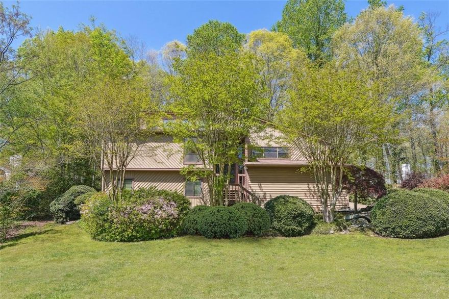 Step into the charm of this classic mid-century split-level home, perfectly situated in the well-established Willow Point neighborhood in East Cobb's Walton High School district. Featuring 3 bedrooms, 2 and a half bathrooms (the half bath has the potential to become a full bath) and over 1,900 square feet of versatile living space, this property is bursting with potential for those looking to restore or reimagine a timeless design. Original paneling, expansive windows and sliding doors, a statement fireplace, and clean architectural lines offer a solid foundation for your vision as evidenced in the photo renderings! The split-level layout provides functional separation of space, with a bright main living area, kitchen with a breakfast area, lower-level family and recreation room, and private upstairs bedrooms. Outside, a spacious backyard awaits your creative touch—ideal for outdoor entertaining, a garden retreat, or future expansion. Whether you're a renovator or a homeowner ready to add your personal touch, this is a rare opportunity to make this home your own in one of the best swim/tennis neighborhoods East Cobb has to offer. Don’t miss the chance to unlock the potential of this unique home on a large lot!