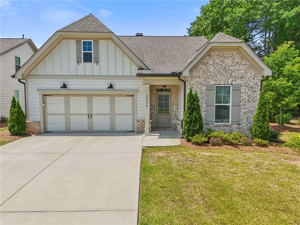 Looking for new construction interest rates on a resale we have it through our preferred lender, offering a 3.99% fixed interest rate with 100% financing on a 30-year loan—with no fees, no points, no PMI and no down payment. This home shows like New Construction and is located in a highly desirable, gated, 55+ Marietta Community. From the curb you experience inviting Southern Charm with luxurious brick and decor that says “I’m Home”. Step inside to find gleaming hardwood floors throughout the main level, adorned with coiffered ceilings in the family room that perfectly accents the home, creating ambiance for relaxing in front of a cozy fireplace framed with a built- in bookcase. The chef’s kitchen is a standout, with an over sized center island featuring quartz counter tops with abundance of cabinet space. The spacious primary suite boasts vaulted ceilings, dual vanities, custom tile, walk-in closets with California Closet shelving and a mega shower, a definite show stopper, is the star of the room. The upstairs features a huge additional bedroom/bonus family room or loft, it is an amazing space for entertaining or it can be used as a secondary Master Bedroom. Upstairs features brand-new Stain Master carpet with Elite double padding for digging your toes in comfort. A heated and cooled attic workshop/storage room is an added bonus for hobbies or organizing. Enjoy year-round outdoor living in the over sized, fully screened patio with custom tile, ceiling fan, and a doggy door—leading to a private, fenced backyard with shade and room to relax. The community features a clubhouse, dog park, lawn maintenance with irrigation, security gate and so much more. With its mix of elegance and everyday comfort, 2335 Plummer Pl. offers everything you need in a forever home. Don’t wait—homes of this quality in Marietta’s 55+ communities don’t last long. Schedule your private tour today!