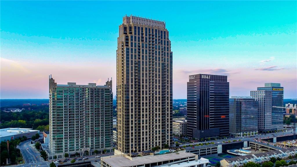 Million Dollar Views! Spectacular unobstructed panorama of Atlanta! Oversized one bedroom with a bonus half bath for guests. Huge floor to ceiling windows with custom shades. Double balconies, one off the living room and one off the bedroom. Well appointed kitchen offers a breakfast bar, stainless appliances, gas cooking, and granite countertops. Open floorplan with plenty of room for dining table and or office space. Large bedroom will easily accommodate a king bed and dressers. Big walk in closet. Private main bathroom with double vanities, walk in shower, garden tub, separate WC, and linen closet. Wide plank hardwood flooring in the main living area. Move in ready. Owners enjoy grand amenities like resort style pool and sundeck, outdoor grilling area, outdoor lounge area with stone fireplace, fully equipped fitness center, clubroom with catering kitchen, game room, gated parking garage, guest parking, concierge, and on site maintenance personnel. All the shops, gym, restaurants, and entertainment venues like Regal movie theatre, LA Fitness, Yard House, Bowlero, Ikea, Publix, Target, and Dillards are located just outside your front door. The Atlantic is one of the most luxurious condo buildings in the Southeast with large floorplans and high end finishes throughout. Welcome home to The Atlantic!