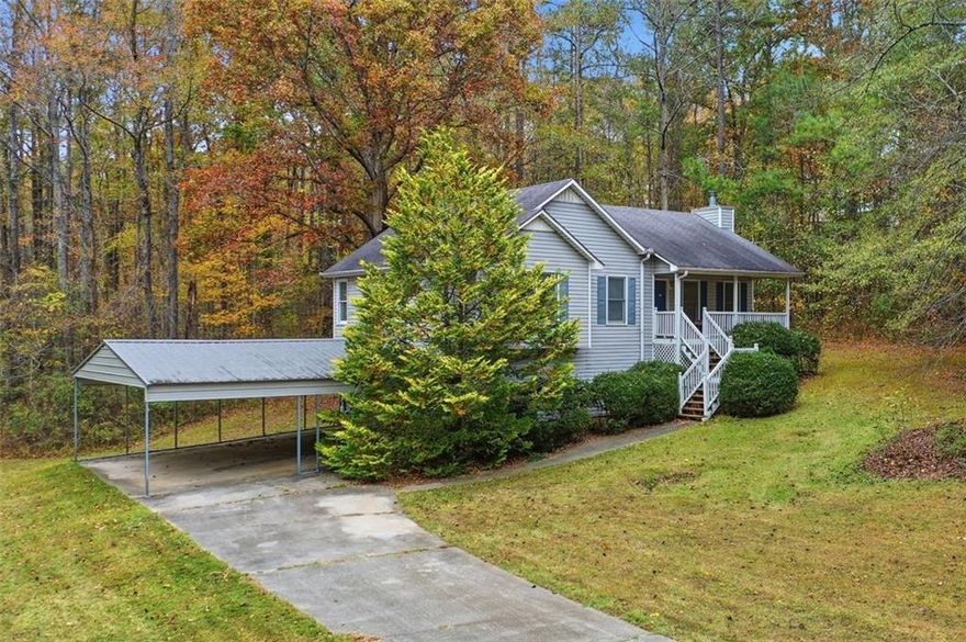 Discover the perfect blend of country charm, privacy, and comfort on this beautiful 3.37-acre property in Paulding county. The moment you step onto the property, you’ll be surrounded by calm, privacy, and the beauty of nature. What truly sets this property apart is everything it offers beyond the home. The land is a dream come true for anyone who loves the outdoors or wants room to grow. You’ll find a private fenced vineyard with six lush rows with a variety of muscadine grapes, each approximately 80 feet long, accompanied by blueberry shrubs and a fig tree, all thriving within the vineyard. This space is ideal for cultivating your own sweet wine or simply enjoying fresh fruit right from your backyard. Surrounding the vineyard is ample open space, perfect for beekeeping, gardening, camping, or hosting friendly gatherings in the heart of nature. A four-bay pole barn with an extra covered storage right across adds even more versatility for tools, equipment, or outdoor hobbies. A peaceful spring fed flowing creek originates near by and runs through the side lot of the property, adding soothing sounds to the charm and serenity of this private retreat.
The home itself complements the beauty of the land perfectly. Step inside to find a spacious living room with a cathedral ceiling and wood-burning fireplace, a bay window in the dining area overlooking the property, and a comfortable layout that makes daily living and entertaining effortless. The primary suite includes a walk-in closet and a private bath with a garden tub and separate shower. The front porch is perfect for enjoying your morning coffee or relaxing in the evening, while the back porch is ideal for a BBQ and entertaining. The basement garage can hold three or more vehicles and offers potential for bonus rooms, workshop, or additional living space, while the attached drive-under garage provides extra car parking and added convenience. Only 15 minutes from shopping, dining, and entertainment, this property gives you the best of both worlds with total country seclusion and easy access to town conveniences.