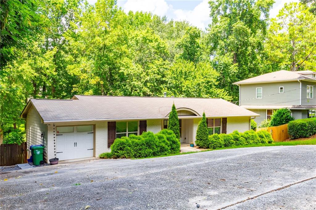 Welcome to this stunning renovated painted brick ranch home, perfectly situated in the highly desirable Ashford Park neighborhood. This 4-bedroom, 3-bathroom property boasts a perfect blend of functionality and elegance, making it the perfect haven for anyone. The main level features an open-plan family room with hardwood floors, crown molding, and a gas fireplace creating a warm and inviting atmosphere. The spacious dining area is perfect for hosting dinner parties, while the gourmet kitchen with stained cabinets, granite countertops, stainless steel appliances, and a breakfast bar counter with beadboard trim is ideal for cooking up a storm. The master suite is a serene retreat, complete with an oversized walk-in closet and a spa-like en-suite featuring dual vanities, and a frameless glass walk-in shower. Two additional bedrooms and two bathrooms on the main level provide ample space for family members or guests. The fully finished terrace level offers a separate living area, complete with two bedrooms, one bathroom, and a full living room. The open concept layout allows for seamless flow between the dining, living, and kitchen areas, making it perfect for entertaining or relaxing. Laundry facilities and three unfinished storage locations provide additional convenience and storage. The real pièce de résistance, however, is the outdoor oasis. The fenced-in backyard is perfect for outdoor entertaining or relaxation, while the massive oversized brand-new rear deck is ideal for al fresco dining or lounging. The walk-out patio provides a seamless transition between indoors and outdoors, allowing you to enjoy the fresh air and beautiful surroundings. And with electric car charging, you'll have the convenience of charging your vehicle at home. This property offers the perfect blend of style, functionality, and convenience, making it a rare find in Ashford Park. Don't miss out on this incredible opportunity to live in one of the neighborhood's most desirable properties. Contact us today to schedule a viewing and make this house your home! **Professional landscapers twice weekly provided by landlord**
