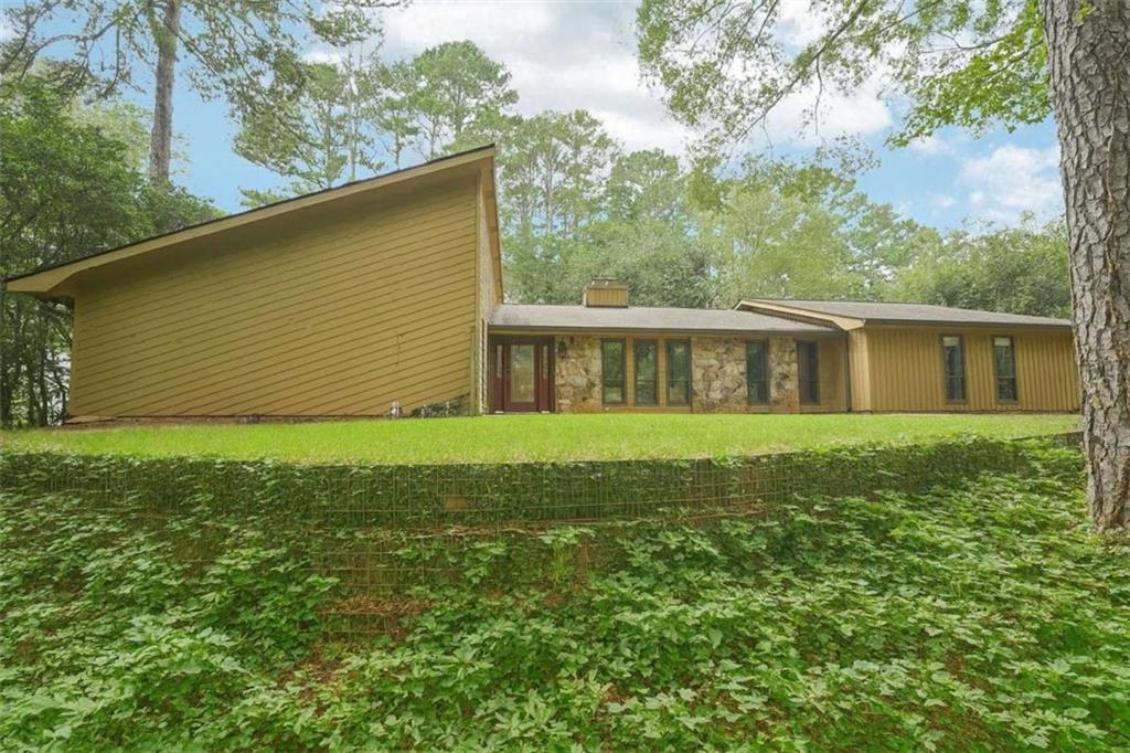 Mid-Century Ranch in Indian Hills – Upgraded & Rare Opportunity! Nestled amidst lush greenery in Marietta’s sought-after Indian Hills subdivision, this upgraded mid-century ranch combines timeless architecture with thoughtful improvements. Recent enhancements include a new roof, beautifully designed retaining walls, and upgraded flooring in the bedrooms, ensuring modern comfort while preserving classic charm. The generous layout offers solid bones and endless potential, serving as the perfect blank slate to add your personal touches. A screened-in porch overlooks the terraced living retaining wall—a serene setting for morning coffee or evening relaxation. Inside, a large flex space provides versatility and could easily transform into a small suite, ideal for multigenerational living, a private office, or guest retreat. Located in one of East Cobb’s most centrally positioned communities, Indian Hills offers optional membership to the prestigious golf club, complete with social, swim, and tennis amenities. This is more than just a home—it’s an opportunity to enjoy upgrades already in place while bringing your vision to life in one of East Cobb’s most desirable neighborhoods.
