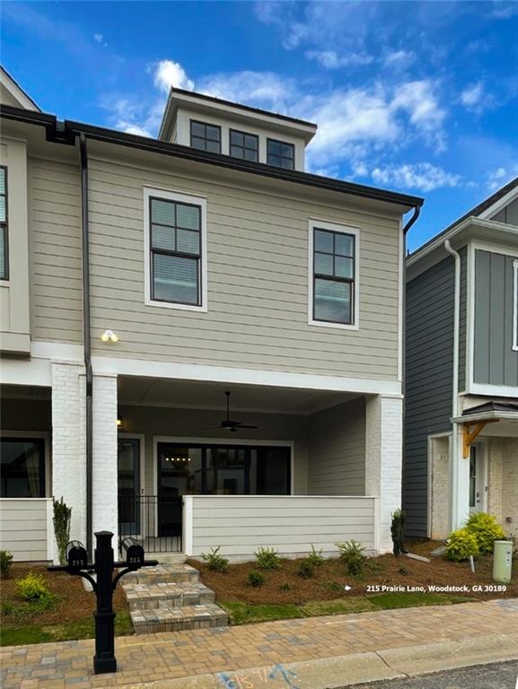 VERY RARE FIND! Gorgeous end-unit townhouse in the coveted Village at Towne Point. This sought after, gated community is within walking distance to some of Woodstocks most popular restaurants, shopping & nightlife, the Towne Lake Pass, Greenprints Trails and more. Walking onto the large front porch/patio from Prairie Lane, you step inside to floor to ceiling sliding glass doors that open to create and even bigger space. The open-concept first floor has a large living area, with mantle and electric fireplace, high-end kitchen with stainless steel appliances and tons of natural light. Three floor to ceiling sliding glass doors can open the entire main level to the outside. Simply walking upstairs, you can feel the quality in this brand-new build, everything just feels top-end. The main bedroom has high ceilings and ample space not common in townhomes. The main bathroom has double vanity, glass shower and a stunning walk-in closet. Bedrooms 2 & 3 face front and are on the opposite side of the unit to give everyone a noise break. The double-door linen closet, and full bathroom in the hallway. Downstairs, off the kitchen in the half-bathroom and garage access with the same 11-foot ceilings that exits to the rear service road. Featuring a Luxurious Clubhouse, State of the Art Fitness center, Swimming pool w/cabana, Pickleball, Bocce ball, Fire pit, Dog park, Vintage looking, gated entrances- both front and back gates. Please see the photo of the rental requirements, must have verifiable income 3 x monthly rent, 1236-month leases are available. No pets.