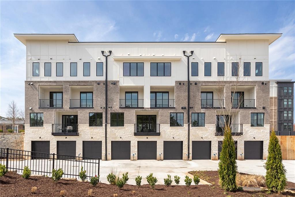 Discover the epitome of modern living in this exquisite End Unit stacked floor plan in Monte Hewett's newest neighborhood in Alpharetta Findley Row where you will enjoy $25,000 Seller paid closing costs with a preferred lender. This is a true lifestyle opportunity to find your new end unit condominium built by the same builder from Avalon, Halcyon and many other well-known neighborhoods. Located on the Alpha Loop and a short distance to Avalon, downtown Alpharetta, the North Point district and the Big Creek Greenway, this luxurious home offers the highest end finishes with low maintenance living. The exterior and interior details are just what you will love in Monte Hewett's amazing designs. You will enjoy White Oak Hardwood floors throughout the home, Quartz countertops in the Kitchen and bathrooms, Bell custom cabinetry throughout the home, tile to the ceilings in the bathrooms, custom light fixtures, covered balcony with storage off the rear and front walkout balcony. You will love the main level that has a completely open floor plan from the Family room to the Kitchen, Dining and walkout covered balcony. The Kitchen features a large island with plenty of room for entertainment and great storage space. Upstairs are two generously sized bedrooms with walk-in closets and private baths. The professional design packages are the perfect color combinations. The oversize two-car tandem garage offers private and convenient parking with tall ceilings that are perfect for storage and an electric car charger outlet. Crafted by Monte Hewett Homes, known for their quality and attention to detail in nearby Avalon and Halcyon, you will want to come see this home today. Findley Row is located in Northwinds Summit that will feature a hotel, retail, dining and office space, as well as very convenient access to GA-400. Enjoy the Alpharetta location without the local traffic. Contact us to schedule a private showing and experience the exceptional lifestyle you will enjoy in Findley Row!
