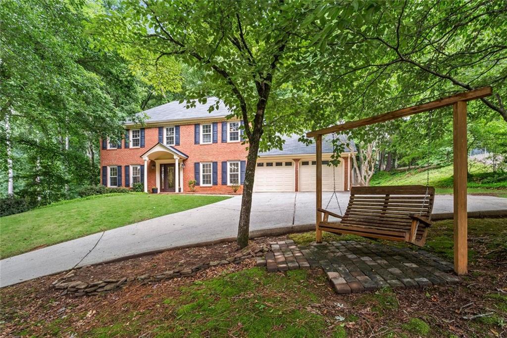 Don’t miss this fantastic 4-bedroom 2.5 bath traditional brick home in the highly sought-after Pope High School district! Located in the vibrant Wicks Creek swim/tennis community, this beautifully updated home is move-in ready and offers all the modern conveniences, plus an amazing private backyard. Perched up on a quiet hill tucked away from major streets and close to the neighborhood amenities, this home will check every box. Step inside and you will immediately notice the gorgeous hardwood floors and updated light fixtures throughout the main level and portions of the upstairs. The completely renovated kitchen (2024) is a chef’s dream, featuring ceiling-height custom cabinetry, quartz countertops, a new LG electric range with custom vent hood, an oversized farmhouse sink, new refrigerator, and dual pantries. There’s also countertop seating and a sunny breakfast nook with views of the lush, walkout backyard. The adjacent laundry room is conveniently located off the kitchen and provides access to the upstairs bonus room via a private back staircase. The spacious family room is filled with natural light and features a wood-burning fireplace with gas starter. You'll also find a formal dining room and a versatile living room that easily functions as a home office. Upstairs, the oversized primary suite boasts a renovated en suite bath with soaking tub, separate water closet, and a walk-in closet with an organization system. Three additional bedrooms—each with walk-in closets—share a full hall bath. The fully fenced backyard is designed for enjoyment with a stone patio, firepit area, walkways, and a storage shed—plenty of room for entertaining, play, or quiet evenings outdoors. This home is truly maintenance free with ALL systems having been replaced in the last five years including roof, gutters, windows, HVAC and hot water heater. Wicks Creek offers a true sense of community, complete with a pool, two tennis/pickleball courts, playground, and a large open play field directly across the street. Just minutes from top-rated schools, shopping, dining, and East Cobb Park—this is the perfect place to call home!