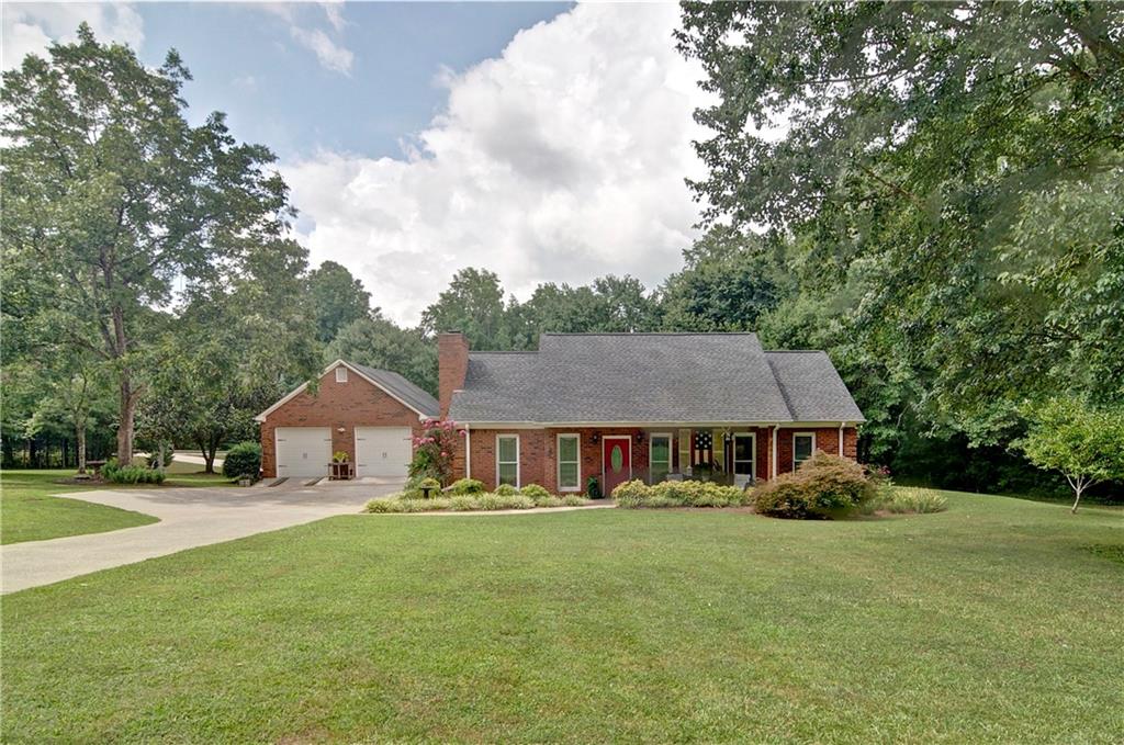 This stepless ranch is four sided brick and offers custom interior features on over an acre. The owners' years of custom building and decorating experience is evident in the designer features of this charming home. Featuring three bedrooms, three full baths, a great room, separate dining room and updated kitchen, this property has been meticulously maintained. The master bedroom and an additional bedroom both have en suites and the dining room boasts a masonry fireplace while the great room has a built-in electric fireplace. There is new flooring in the living area and plenty of storage space throughout. Stainless steel refrigerator, washer & dryer included. The spacious two car garage is insulated with heat and air conditioning creating a great area for a workshop or for car enthusiasts and it has a full floored attic for loads of additional storage. There are two covered porches and a back yard deck for outdoor entertaining. The roof is only five years old and the HVAC system is routinely serviced. There is NO HOA. While giving a "country living" feel, this gem is conveniently located near shopping and schools. Don't miss this great home...priced to sell!