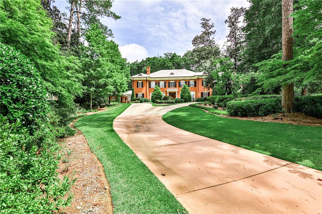 Located in prestigious Buckhead on a private 1.7-acre lot in Tuxedo Park, this beautiful four-sided brick estate home was designed by Brian Smith & built by RL Connelly & Co.  Located off the street with a private sweeping driveway and courtyard that leads to the beautifully landscaped pool area and private, wooded grounds.  An expansive floorplan with two-story foyer, splendid millwork, exquisite stone details, ornate coffered ceilings, five masonry fireplaces with onyx surrounds, dual staircases, and abundant natural sunlight. The chef’s kitchen features cherry cabinets, natural stone countertops, a double island, Wolf appliances and is located adjacent to the butler’s pantry, formal dining room that seats 12+, relaxing breakfast room and a 12.5 ft vaulted ceiling-keeping room with a fireplace and built-in bookshelves. The family room features an intricate coffered ceiling, fireplace, spacious seating area and a series of French doors that lead onto the covered patio and pool area. The master suite, located on the main floor, impresses with a palatial, light-filled bedroom with a sitting area, fireplace, enviable walk-in closets with custom cabinetry and a luxurious, spa-inspired bathroom­–featuring separate vanities, a soaking tub, and a marble shower.  Upstairs, there are four secondary bedrooms with generous closets, ensuite bathrooms and a media room. The 6th bedroom and bathroom, located above the three-car gated access garage, is the perfect au pair or in-law suite.  The finished Terrace Level is perfect for entertaining with an inviting bar, wine cellar and lounge or media viewing room, in-home sauna, and walk-out access to the heated pool, gazebo, and covered patio area.  Located on iconic Habersham Road, this property offers unparalleled convenience to Atlanta's best schools, country clubs, shopping, dining spots, and nearby Chastain Park.  Some rooms have been virtual staged. Virtual staging reflects change of paint color and furniture only. Taxes do not reflect Homestead Exemption.