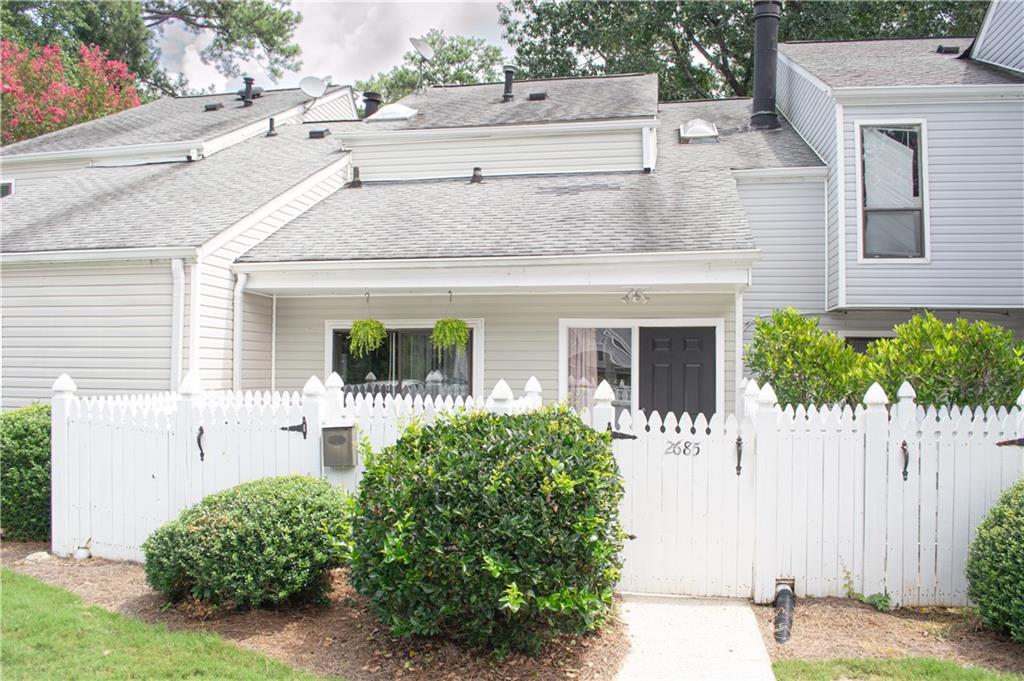Welcome to this beautifully maintained 2 bed, 1.5 bath condo offering comfort, convenience, and charm. Thoughtfully updated throughout, this home features tall ceilings, spacious living areas, and stylish finishes that make it truly move-in ready. Enjoy two private fenced patios - one in the front and one in the back - perfect for relaxing, entertaining, or gardening. The layout of this home creates a warm, inviting atmosphere while maximizing functionality. Nestled in a well-kept community, yet just minutes from highways, shopping, schools, and everyday conveniences, this property strikes the perfect balance of peace and accessibility. Whether you're looking for a new place to call home or an excellent investment opportunity with long-term rental potential, this condo is a MUST-SEE!