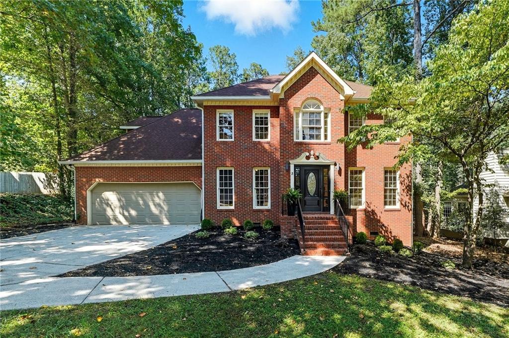 Feel the love that went into this highly functional and modernly customized home. A rare 1/3 acre lot with nothing behind but green space and deer tucked in the back of the rolling hills and mature trees of the Milford Chase subdivision. Enjoy your daily coffee in the picturesque open kitchen with modern appliances, an oversized farmhouse sink, and floating shelves that feel more like a serene vacation. While the timeless light fixtures, unique window treatments, and custom millwork in nearly every room romanticize even your most mundane daily activities, the fully or partially refinished bathrooms, two powerful new A/C units, and recently cleaned duct work allow for a relaxed and comfortable lifestyle. Work from home in the Zoom-ready office. Cozy up around the fire pit in the fall. Enjoy holidays next to your wood burning fireplace—with gas starter—and enough clearance to fit a real 8 foot tree with room to spare. Spend evenings on the miles of walkable sidewalks throughout the neighborhood or with a glass of wine on your expansive and newly refinished deck. Over the weekend, take the short 7 minute trip to 60 miles of Silver Comet trail or head 8 minutes the other way to a quiet trailhead in Kennesaw Battlefield National Park then pop into one of the many brand new Atlanta-esque restaurants in this up and coming area.