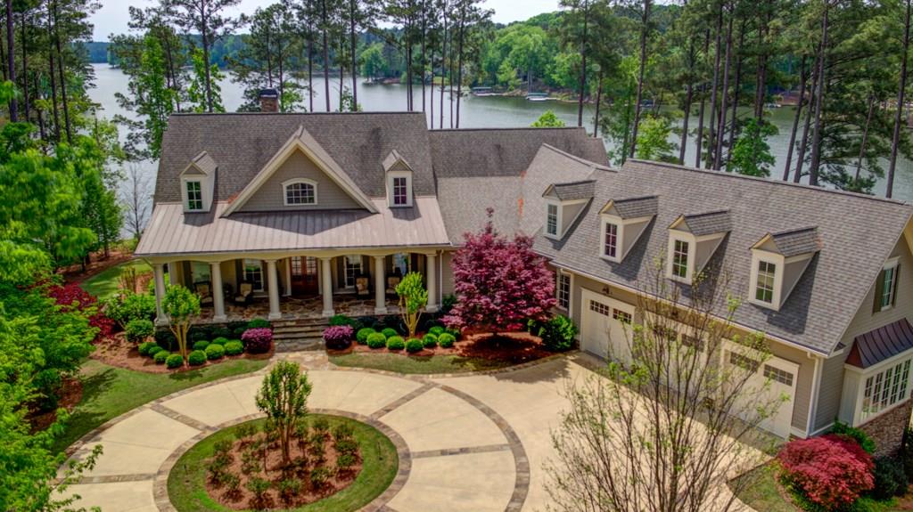 Premier, custom built home- true entertainer's delight on Lake Oconee in Reynolds Lake Oconee. W'ful open floor plan w/ Gourmet Kit by Habersham, bfst area open to fam rm w/FP, sep DR, screened porch w/FP & covered back deck, stunning master ste w/ FP, sitting rm, lux master bath & custom closet, 2 secondary BR/BA. Upstairs w/ bonus rm w/ wet bar & 2 BR/2BA. Full, fin terrace lvl w/ 2BR/2BA, living area w/ 2nd kit open to covered patio & pool, wine cellar, exercise rm, game rm & home theatre. Stunning lake views, firepit, 6 car gar & Max dock complete this amazing home.