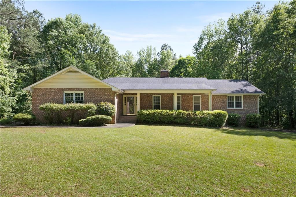 Welcome to this charming custom home that has been beautifully maintained and sits on 3.94 acres of land. This 4 side brick ranch plan with a full basement, provides ample living space and versatility.
The heart of this home is the spacious kitchen, featuring an abundance of cabinet space, a kitchen island, and an oversized walk-in pantry. The fireside family room provides a perfect space for gatherings and relaxation. The master suite is a true retreat, with an updated master bathroom that includes a large tile walk-in shower, walk in closet and 2 additional closets.
This home also features a separate entrance and driveway for the basement. With a bedroom and bath in the basement, this home offers the convenience of multi-generational living or a private and convenient living space for guests.
Additional features include a detached garage, a rocking chair front porch, and a large screened back porch for enjoying the serene views of the private lot. This solid-built home has been well maintained and is convenient to shopping, restaurants, and the interstate. Don't miss your chance to make this beautiful property your own!