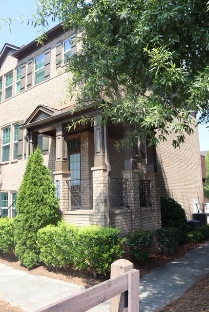 end unit with large covered front porch. Open floorplan, kitchen with SS appliances, granite counters, tile backsplash, island/breakfast bar, breakfast area and view to fireside family room and back deck. Additional room up front great for dining room, office family room etc. Master suite upstairs with additional full bedroom/bath. Two car garage on terrace level with third bedroom & full bath. Close to GA 400 and major retail, dining & parks/recreation areas.