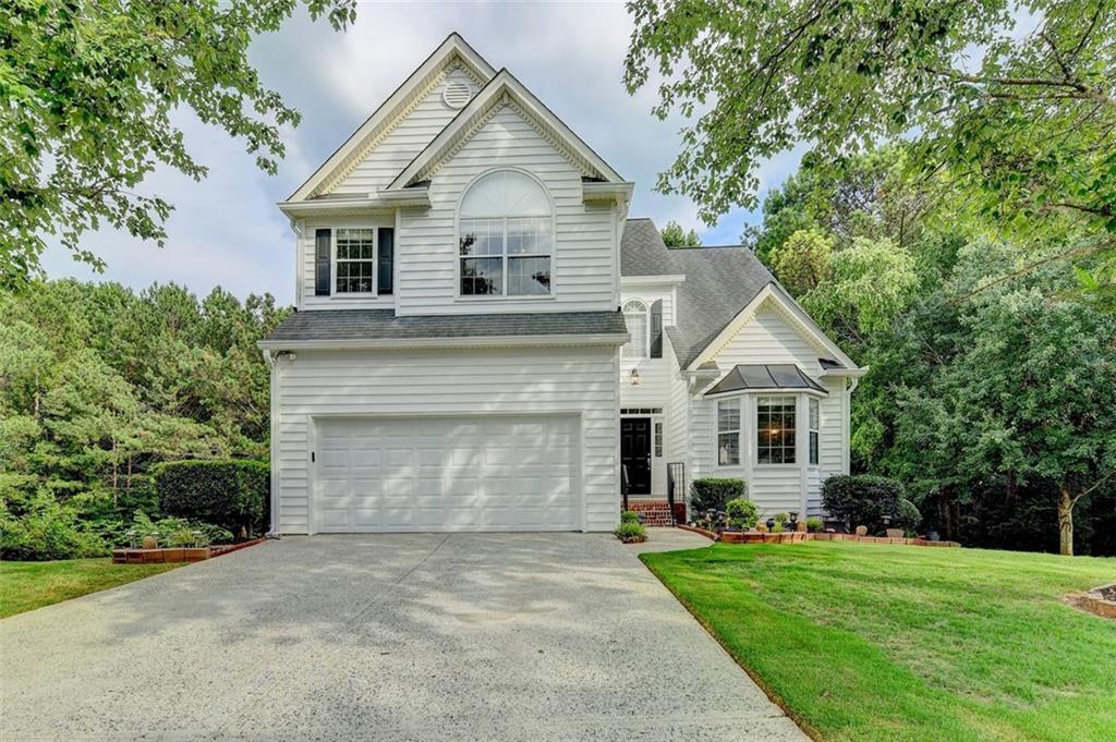 Welcome to beautiful home w/FINISHED BASEMENT move in ready in the sought-after AVENSONG Community - nestled in a quiet cul-de-sac, surrounded by lush woods. This property stands out with an inviting two-story foyer that introduces a generous dining room and flex space that can be used for either living or office. Gorgeous Kitchen features-stained cabinets, stainless steel appliances, granite counters, and the breakfast area bathed in natural light from the wall of windows, offering stunning views of the meticulously landscaped backyard. The breakfast area opens to the cozy 2-Story family room and fireplace, setting the perfect scene for relaxation and entertainment. Outdoor living reaches new heights on the large deck, perfect for enjoying sunset evenings, stargazing, and gathering around the expanded flagstone patio. The main level also features a powder room. Ascend to the upper floor to discover the exquisite master bedroom, complete with a vaulted ceiling and an adjoining sitting entertainment space for ultimate relaxation. The master bath offers double vanities, a garden tub, and a separate shower leading to a walk-in closet. Two additional bedrooms, and a full bath completes the upper level. Industrial-inspired Finished, daylight terrace level is perfect for entertaining that includes a play area and media room. This home has been meticulously maintained and features numerous renovations. Situated in a family-friendly community with amenities that include a pool, clubhouse, and lighted tennis court. This property also benefits from being in a zone with award-winning schools. Conveniently located near Avalon, Alpharetta Downtown, Halcyon, and SR 400, this move-in ready property offers the perfect blend of tranquility and accessibility. Do not miss your chance to own a piece of paradise in Alpharetta!