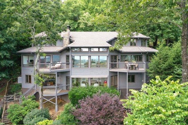This is the GA mountain retreat you have been looking for! It is a spectacular custom Home nestled in the mountains of Big Canoe. Enjoy short and long views as far as the Atlanta Skyline. Artist/Architect designed, this home with its open floor plan, seamlessly integrates nature into every corner. Antique pegged wide-pine floors, exposed beams, and abundant windows create a bright and inviting atmosphere. Step outside to admire the beautiful gardens and pet-friendly yard, complete with several private patio areas perfect for outdoor entertaining. Remote control awnings over the living room windows ensure optimal outdoor exposure. Too many special features to mention. You must see it to appreciate the craftmanship. Welcome to your new mountain retreat with a private view from 'every' angle. Welcome to North Georgia and the southern point of the Appalachian Trail.