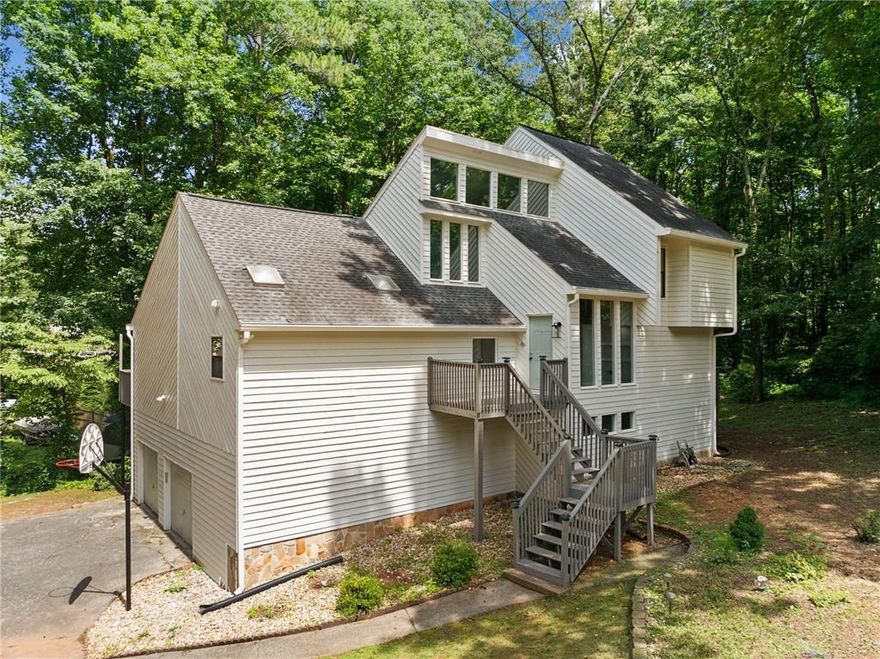 Exceptional in the Highly Desired Lashley Farms Neighborhood, close to all that East Cobb has to offer and minutes to Shopping and Dining. This private retreat is situated perfectly in the neighborhood with an Expansive Open Floor Pan. Newly Painted Exterior Welcome you as you Enter the Two Story Foyer in this Immaculate home w/ Freshly Painted Interior and Beautifully Renovated. Sunny & Bright Chef's Kitchen w/ White Kitchen Cabinets w/ Plenty of Pull-Out Shelving, Granite Counters, Island, Updated Lighting Fixtures, Gas Range w/ Vent hood, Tiled Backsplash & Pantry w/ Views to the Family Room & Views to the Private Backyard. Family Room with Stone Fireplace Overlooks Yard w/ Two Decks! The Formal Dining Room w/ Large windows offers plenty of Natural Light & is perfect for Entertaining. Powder Room w/ Updated Vanity, Faucet & Light Fixture. Upstairs Enjoy the Massive Owners Suite w/ Vaulted Ceiling, Walk-In Closet & the Owner’s Suite Bath w/ Updated Luxury Vinyl Floor, Oversized Vanity w/ Dual Sinks, Free Standing Tub & Separate Tiled Shower! Master Suite w/ Private Deck. Two Secondary Bedrooms Upstairs Share the Updated Secondary Bath. Loft Space Upstairs. Finished Basement w/ Bar, Family Room w/ Fireplace & Built ins & Fourth Bedroom w/ Bathroom.  Additional Storage in the Basement & Garage.  Private & Wooded Backyard is the perfect space to relax. This home is located minutes to private schools Mt. Bethel, East Cobb & Top Rated Public Schools. Upgrades include New HVAC (Upstairs) – 2025. New HVAC (Main) - 2023 w/ Lenox S40 Smart Thermostat. New Paint (Interior & Exterior) – 2025. New Luxury Vinyl Flooring (Kitchen & Master Bath & Basement Bath) – 2025. All New Light Fixtures - 2025.  All New Plumbing Fixtures - 2025. Roof - 2019.