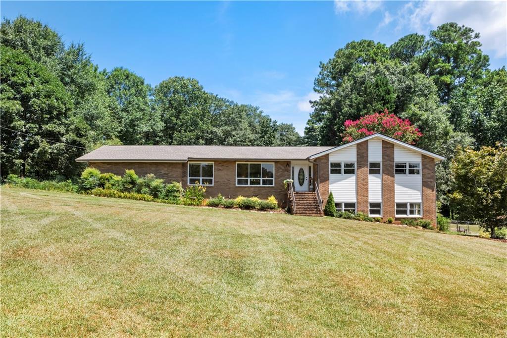 West Cobb. Here’s your opportunity to own 1.9 acres of land featuring fruit trees in a very private setting. This charming 4-sided brick ranch includes a full basement and a sunroom that overlooks your secluded backyard. Located within the Harrison High School district, you'll be close to shopping, dining, and pickleball courts just down the road. The basement boasts a bonus room that can serve as a fourth bedroom, along with a couple of additional rooms. Best of all, there is NO HOA! Don’t miss out on this fantastic opportunity.